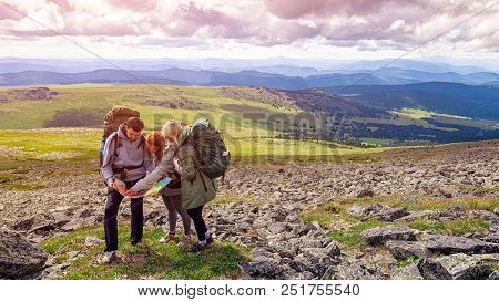 Travel Lifestyle And Survival Concept Rear View. Hiking Man And Women With Backpack Enjoys A Hike  A
