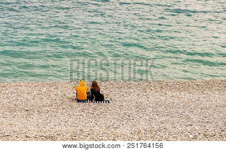 Couple Turned Back To The Camera Looking At The Sea, Relaxed, Concept Of Freedom.
Lovers Waiting For