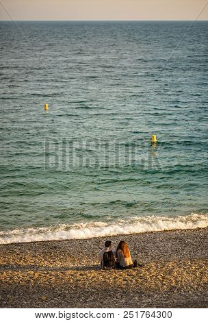 Couple Turned Back To The Camera Looking At The Sea, Relaxed, Concept Of Freedom.
Lovers Waiting For