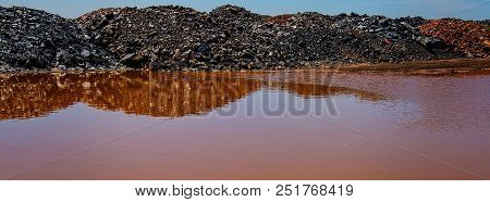 Waste Of Mining Industry Rainwater Colored With Ferrous Salts, Pollution Of The Environment. Web Ban