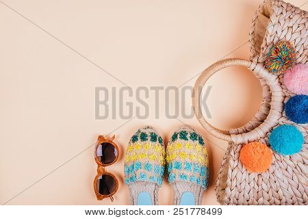 Summer Fashion Flatlay With Brown Sunglasses, Trendy Straw Bag With Pompoms And Gradient Espadrille 
