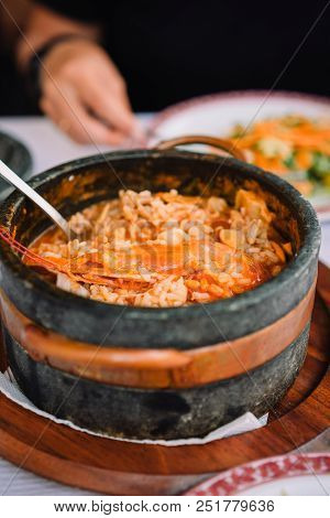 National Cuisine Of Cape Verde: Cachupa With Prawn In Traditional Stone Bowl.