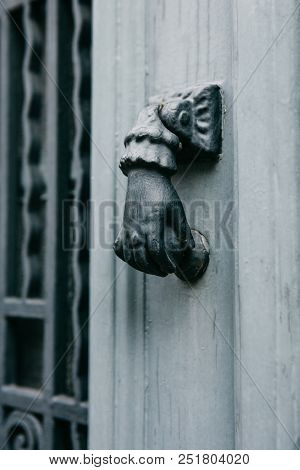 Close-up. Vintage Handle For Knocking On The Door In The Form Of A Hand. Entrance To The Apartment B