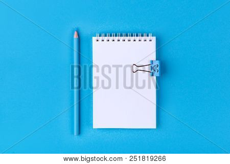 Top View Of Blank Notebook With Peb On Colorful Background Blue With Copy Space.