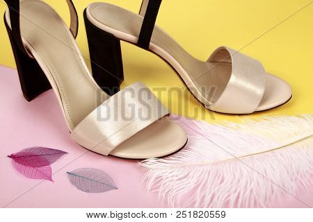 Woman Summer Shoes With Accecories On Pink And Yellow Background