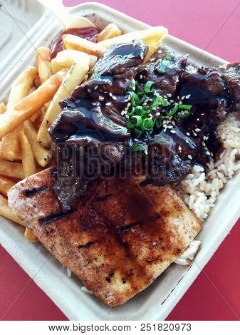 Mauka - Makai: Bbq Kalbi And Ono With Rice And French Fries On A Biodegradable Container Plate.