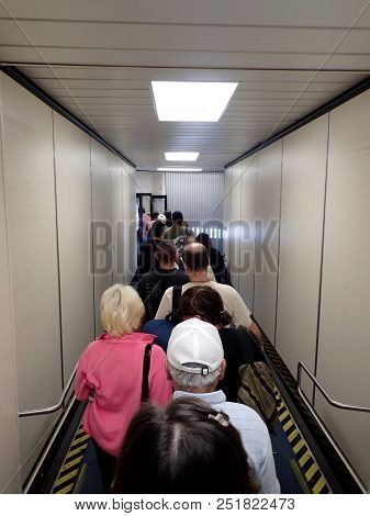 Honolulu - November 9, 2014: Line Of People Boarding Airplane Down Long Ramp At Honolulu Internation