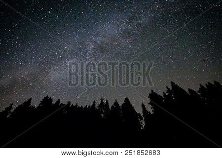 A View Of The Stars Of The Milky Way With A Mountain Top In The Foreground. Night Sky Nature Summer 