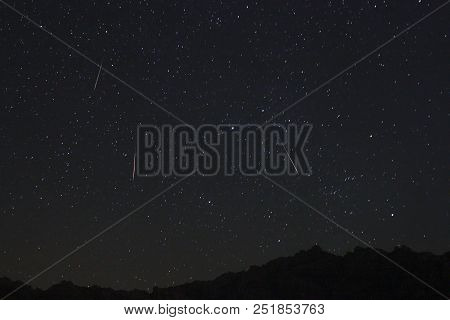 A View Of The Stars Of The Milky Way With A Mountain Top In The Foreground. Night Sky Nature Summer 