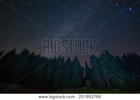 A View Of The Stars Of The Milky Way With A Mountain Top In The Foreground. Night Sky Nature Summer 