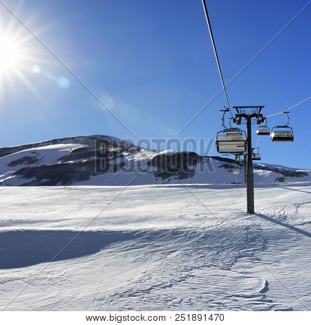 Chair-lift And Blue Sky With Sun And Sunbeams. Greater Caucasus In Winter, Mount Shahdagh, Azerbaija