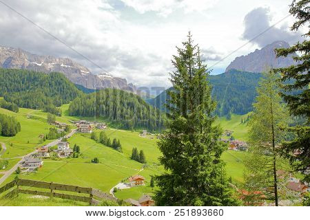 Selva Viewed From The Way Of The Cross With Sella Group Mountains (on The Left) And Sassolungo Mount