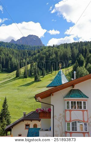 Close-up On A Facade In Selva With Meadows, Forest And Sassolungo Mountain In The Background, Val Ga