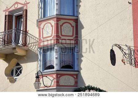 Val Gardena, Italy - June 29, 2018: Close-up On A Colorful House Facade With Carvings And Paintings 