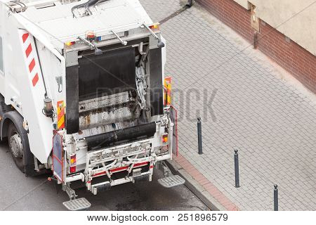 Modern White Garbage Dustcart Truck On City Street. Recycling In Town Concept.