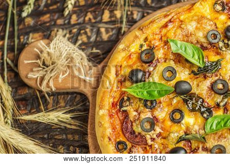 Traditional Pizza With Cheese, Tomatoes, Black Olives, Basil.
