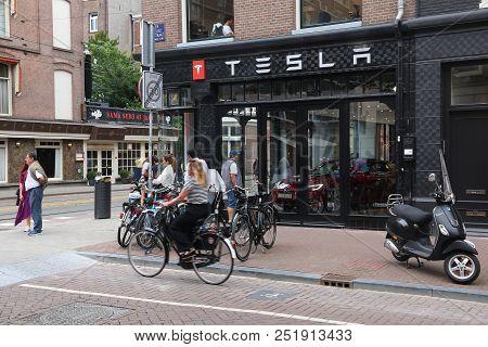Amsterdam, Netherlands - July 10, 2017: People Visit Tesla Car Dealership In Amsterdam. Pieter Corne