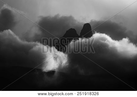 Two High Mountains Can Be Seen From Behind The Clouds