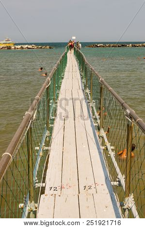 Pier In Stainless Steel And Wood Allow The Boarding Of Tourists On The Boats Of Igea Marina Near Rim