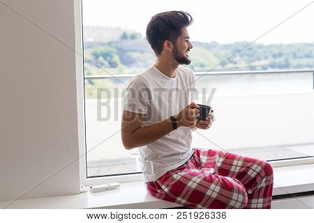 Young Man Drinking Coffee In The Morning