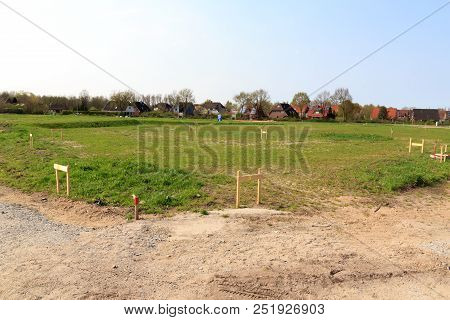 Building Lot Site With Grass After Stakeout Measurement Survey Ready For Construction, Germany