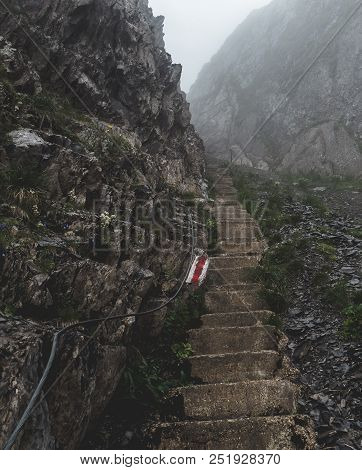 Scary Steep Hiking Path With Stairs On Steep Mountain. Hiking Path Sign On A Stone, Brienzer Rothorn
