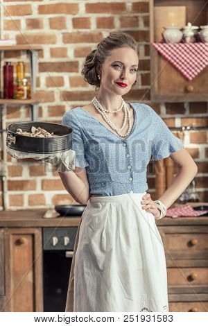 Beautiful Adult Housewife Holding Baking Trey At Kitchen