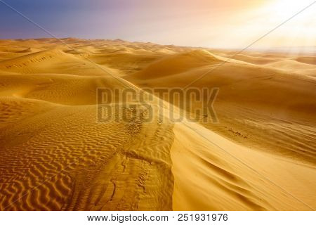 Sand dunes in the desert near Al Ain, UAE at sunrise
