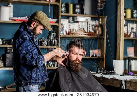 Barber With Hair Clipper Works On Hairstyle For Bearded Man Barbershop Background. Barber With Clipp