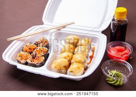 Set Of Sushi Rolls. Delivery Of Asian Food Home. Sushi Rolls In Thermal Box With Imber, Wassabi And 