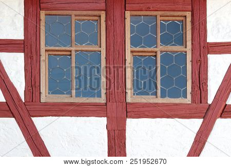 Leaded Glass Windows, Framed Oxblood Red Beams, Half-timbered Construction Of An Historic House