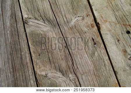 A Greyed Weathered Wooden Deck In The Afternoon Sun