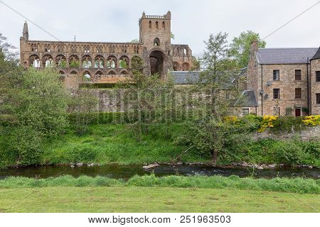 View At Ruins Of Jedburgh Abbey In Scottish Borders. In Front Jed Water River