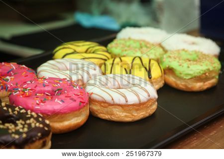Colorful Donuts Close-up On The Window Of A Street Cafe