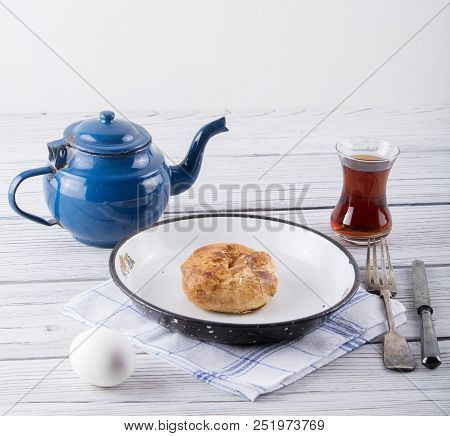 Turkish Borek Boyoz With Egg And Tea On Wooden Background