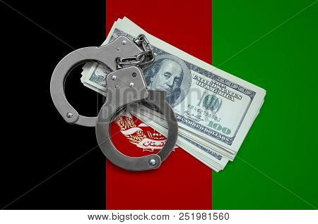 Afghanistan Flag With Handcuffs And A Bundle Of Dollars. Currency Corruption In The Country. Financi