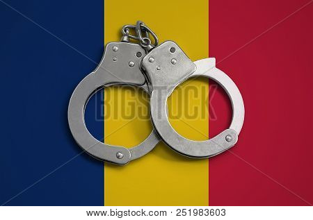 Chad Flag  And Police Handcuffs. The Concept Of Observance Of The Law In The Country And Protection 