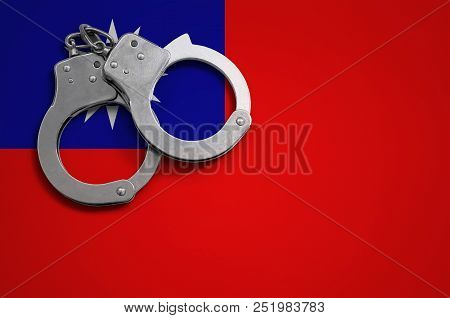 Taiwan Flag  And Police Handcuffs. The Concept Of Crime And Offenses In The Country