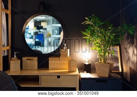 Sitting Corner With Wooden Table, Green Plant In Flowerpot, Round Large Mirror And Night Lamp. Cozy 