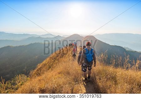 Beautiful Landscape With Trekkers Walking On Mountain Ridge In Sunset At Thong Pha Phum National Par
