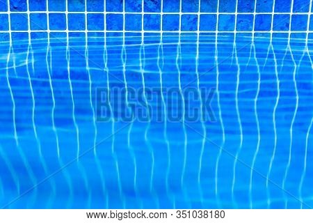 Pool With Water Edge Background. Side Front View Of Swimming Pool Border Close-up. Surface Of Blue P