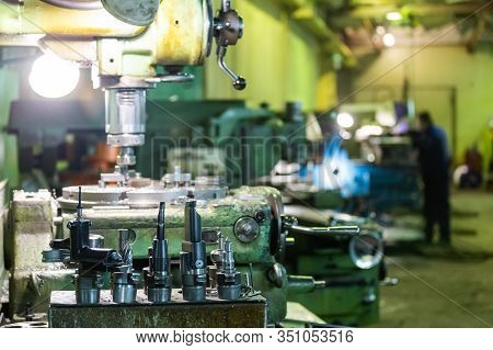 A Set Of Metalworking Tools In Front Of Manual Vertical Milling And Boring Oldschool Machine Indoors