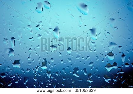 Moisty Wet Window With Water Running Down The Surface. Window Glass After Heavy Rain. Abstract Blurr