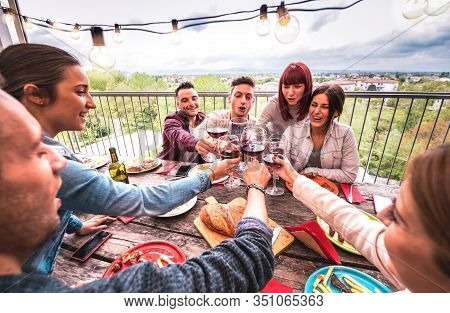 Wide Angle View Of Happy People Toasting Red Wine Together At Rooftop Party In Open Air Villa - Youn