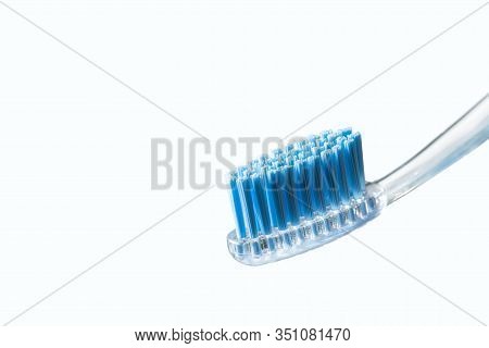 Toothbrush And Toothpaste On Blurred Background. Care For The Oral Cavity And Teet