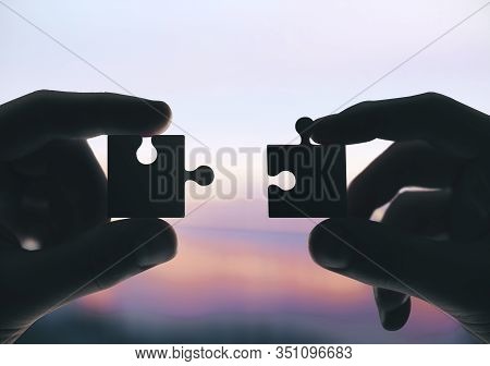 Hands Putting Puzzle Pieces Together. Close Up. Business And Challenge Concept.