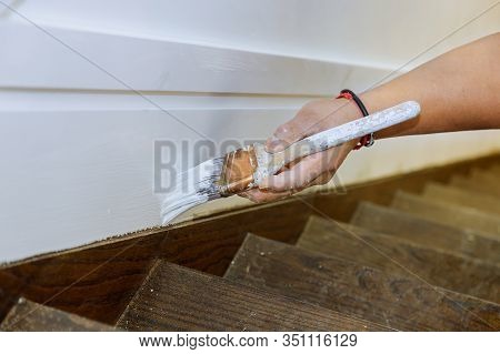 Professional Painter Cutting In With Brush Man Is Painting Molding Stairs Flooring With Brush