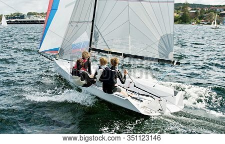Children Sailing In Small Colourful Boats And Dinghies For Fun And In Competition. Teamwork By Junio