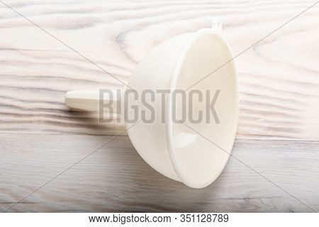 White Plastic Funnel Liquid On Wood Kitchen Table Background
