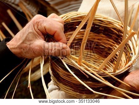 Hand Of Senior While Made A Wicker Basket